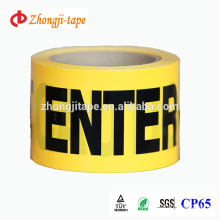 yellow film with black printing words warning barricade tape